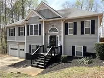 Charming two-story home with gray siding, stone accents, and a welcoming front porch with black shutters at 1380 Cedar Hl, Douglasville, GA 30134