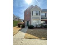 Charming two-story townhome with brick and siding, featuring a well-manicured lawn and inviting entryway at 2742 Snapfinger Manor, Decatur, GA 30035
