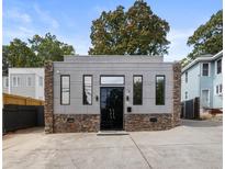 Modern home featuring gray siding, stone accents, and black framed windows at 175 Moreland Se Ave, Atlanta, GA 30316