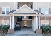 Apartment complex entrance featuring a covered stairwell and access to the units above at 10303 Waldrop Place, Decatur, GA 30034