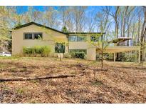 Charming two-story home with a bright exterior, lush front yard, and spacious covered deck for outdoor relaxation at 481 Patillo Rd, Stockbridge, GA 30281