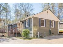 Charming home featuring blue shutters, wood siding, and a welcoming front porch at 524 S Holly Springs Rd, Woodstock, GA 30188