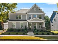 Charming two-story home with gray siding, well-maintained landscaping, and a welcoming front porch at 9884 Ashton Old Rd, Douglasville, GA 30135