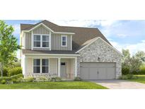 Charming two-story home featuring a covered porch and attached two-car garage at 1763 Fawlocke Run, Loganville, GA 30052