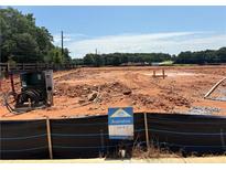 An available vacant lot showcases construction potential against a backdrop of trees and open sky at 6343 Towhee Way, Morrow, GA 30260