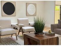 Beautiful seating area with two chairs, wood coffee table and modern art at 541 Earlvine Nw Way, Kennesaw, GA 30152