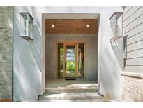Welcoming front entrance featuring modern glass doors and stylish exterior lighting at 402 Chattahoochee St, Roswell, GA 30075