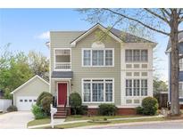 Charming two-story home with a red front door, green siding, and a well-manicured lawn and landscaped front yard at 218 Ridley Ln, Decatur, GA 30030