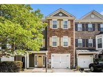 Charming townhome with stone facade, shutters, and a well-maintained front yard at 3956 Church View Ln, Suwanee, GA 30024