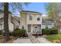 Charming two-story home featuring a cozy front porch, landscaped yard, and neutral siding at 5908 Trent Walk Dr, Lithonia, GA 30038