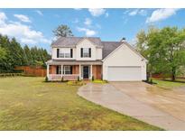 Charming two-story home with a covered front porch and well-manicured lawn at 4264 Parks Ridge Dr, Snellville, GA 30039