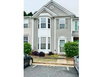 Inviting townhouse with a bay window, neutral siding, and well-maintained landscaping at 4645 Valais Ct # 121, Alpharetta, GA 30022