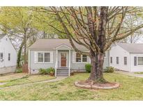Charming single-story home with a well-manicured lawn and a welcoming front porch at 2460 Constance St, East Point, GA 30344