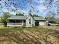 Charming single-story home with a inviting front porch and well-maintained yard at 204 Appalachee Church Rd, Auburn, GA 30011