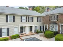 Inviting townhome with a manicured lawn, classic siding, and brick accents create curb appeal at 28 Mount Vernon Cir, Atlanta, GA 30338