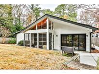 Modern home featuring a screened in porch, expansive windows and sliding glass door to backyard at 3063 Leafwood Dr, Decatur, GA 30033