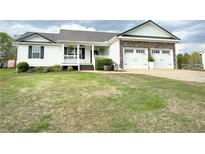 Charming home with a metal roof, stone accents, and a well-manicured lawn at 273 Crowe Springs Nw Rd, Cartersville, GA 30121
