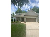 Charming single-story home featuring a two-car garage and a beautifully landscaped front yard at 3455 Buffington Ln, Cumming, GA 30040