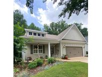 Charming single-story home featuring a well-manicured front yard and a two-car garage at 3455 Buffington Ln, Cumming, GA 30040