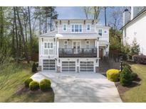 Stunning two-story home features a balcony, three-car garage, and professionally landscaped yard at 3080 Dickson Ne St, Brookhaven, GA 30319
