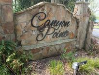 Stone sign identifying the Canyon Point subdivision in an attractive, upscale font and style at 3011 Canyon Point Cir, Roswell, GA 30076
