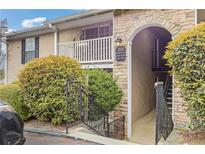 View of exterior featuring stone accents, stairwell to units, and mature landscaping around the building at 3155 Seven Pines Ct # 303, Atlanta, GA 30339