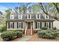 Charming home with a brick walkway, dormer windows and professionally landscaped yard at 4062 Silver Fir Ct, Marietta, GA 30066
