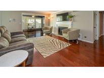 Comfortable living room features hardwood floors, a fireplace, and a cozy seating area at 1602 Gettysburg Pl, Sandy Springs, GA 30350