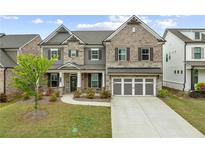 Charming two-story home with stone and brick facade and well-manicured lawn at 4229 Brookmont Way, Auburn, GA 30011