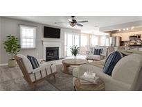 Inviting living room with a cozy fireplace, plush seating, and an open layout to the kitchen and dining area at 68 Hampshire Ct, Avondale Estates, GA 30002