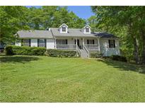 Charming one-story home with a covered front porch and well-manicured lawn at 320 Creek Side Ct, Mcdonough, GA 30252