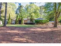 Charming single-story home with mature trees and well-maintained front lawn at 2701 East Mill Se Way, Conyers, GA 30094