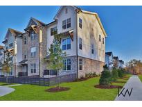 Beautiful townhouse with brick and siding exterior and manicured lawn at 3764 Sage Park Way, Suwanee, GA 30024
