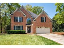 Charming two-story brick home with a well-manicured lawn and attached two car garage at 3225 Warren Creek Sw Dr, Hiram, GA 30141