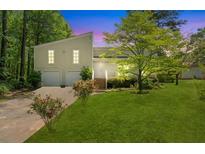 Charming home with a well-maintained lawn, mature trees, and an inviting front entrance at 112 Bernice Dr, Lawrenceville, GA 30045