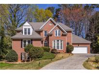 Charming two-story brick home with a well-manicured lawn and attached two car garage at 1864 Crestridge Ne Pl, Atlanta, GA 30345