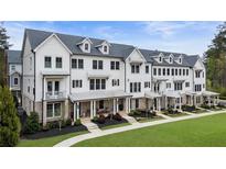 Beautiful townhome exteriors feature white siding, black trim, and inviting front porches at 2068 Cortland Rd, Milton, GA 30009