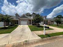 Charming one-story home featuring a well-maintained lawn and a private driveway leading to an attached garage at 340 Rosenwald Ln, Hampton, GA 30228