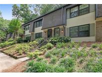 Charming townhouse featuring well-maintained landscaping and inviting entrance at 8 Arpege Nw Way, Atlanta, GA 30327