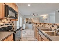 Bright kitchen featuring tile backsplash, stainless steel appliances, and ample counter space at 8 Arpege Nw Way, Atlanta, GA 30327