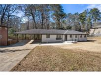 Charming single-story home features a covered carport and landscaped front yard at 2277 Cloverdale Se Dr, Atlanta, GA 30316