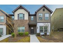 Charming two-story townhome with a mix of brick and siding, offering a welcoming front entrance at 2461 Bayrose Cir, Atlanta, GA 30344