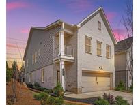 Charming two-story home with white brick and gray siding, complemented by a well-manicured front yard and a two-car garage at 3628 Silvery Way, Powder Springs, GA 30127