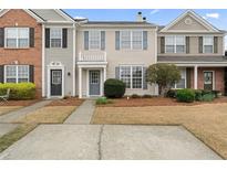 Charming townhouse with blue shutters and a well-maintained front yard at 1730 Stanwood Nw Dr, Kennesaw, GA 30152