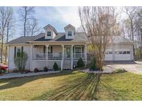 Charming one-story home with a front porch, dormers, well-kept lawn, and an attached garage at 103 New Hood Rd, Stockbridge, GA 30281