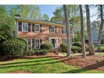 Charming two-story brick home with black shutters and a well-manicured lawn at 3141 Branford Ct, Marietta, GA 30062