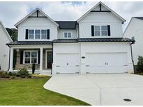 Striking two-story modern farmhouse with a white exterior, black accents, and a spacious two-car garage at 3330 Hillshire Dr, Cumming, GA 30028