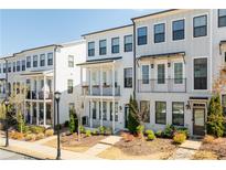 Charming townhome featuring a classic exterior design with inviting balconies and manicured landscaping at 2013 Rockledge Ne Rd, Atlanta, GA 30324