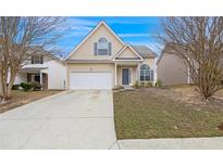 Charming home featuring a two-car garage, complemented by a well-maintained lawn and a welcoming entrance at 2760 Carolina Rdg, Riverdale, GA 30296