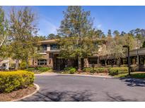 The property features a brick facade, well-maintained landscaping, and a charming entrance, exuding a welcoming atmosphere at 1800 Clairmont Lk # 221, Decatur, GA 30033